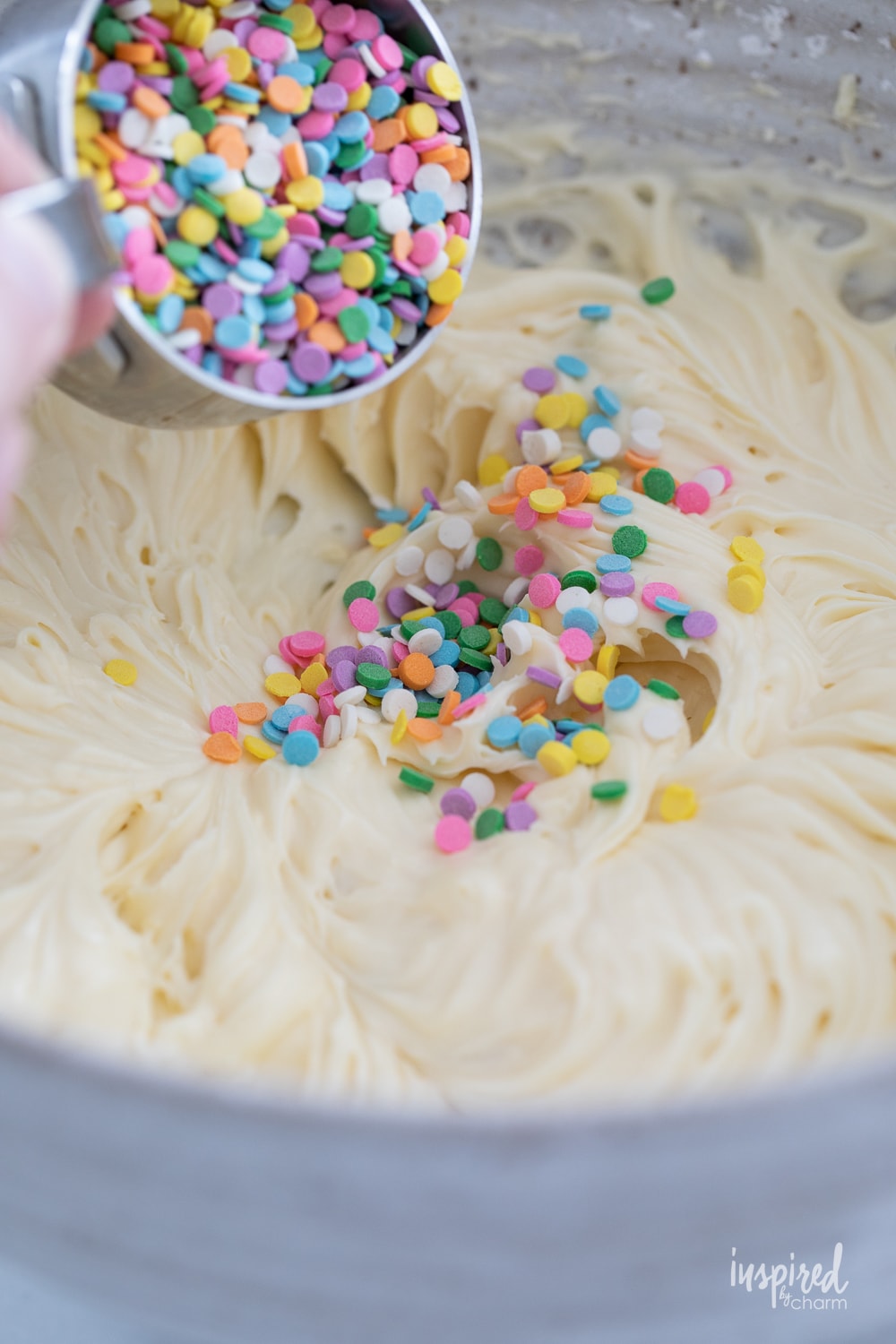 mixing sprinkles into funfetti dip.