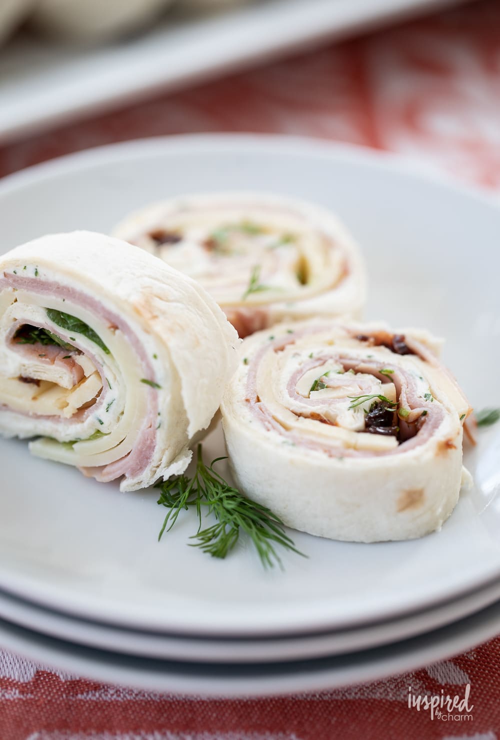 black forest ham pinwheels on a plate. 