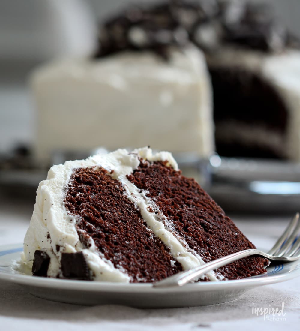 slice of cookies and cream cake on a plate.