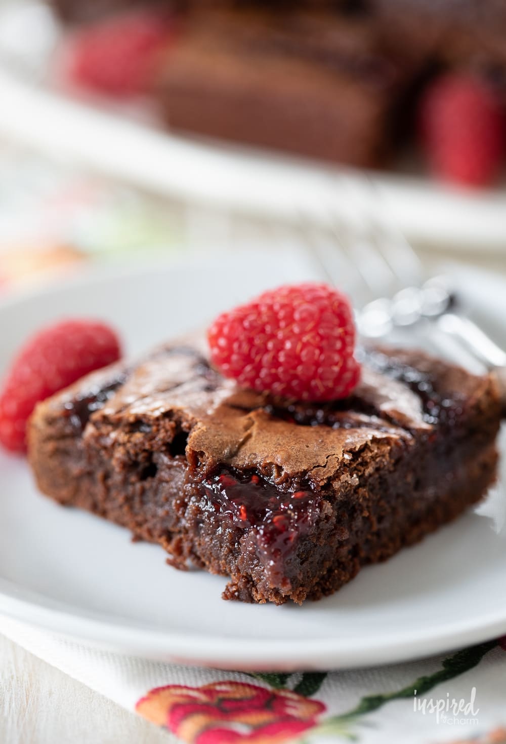 Raspberry Brownie on a plate with fork.