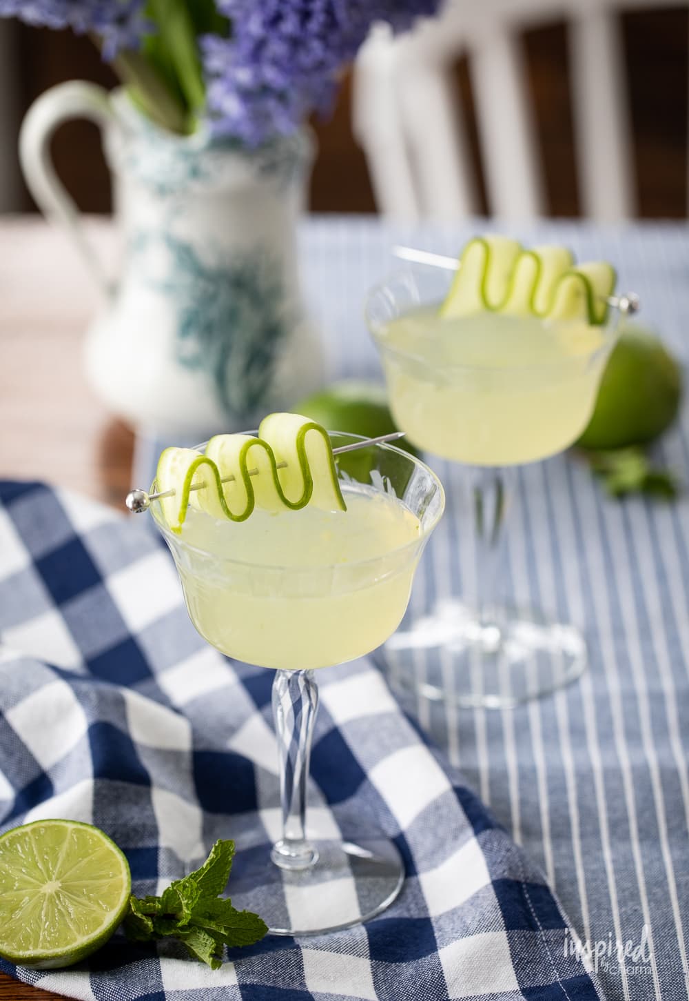 two cucumber martinis in coupe glasses.