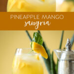 pineapple mango sangria in a glass with mango and basil garnish.