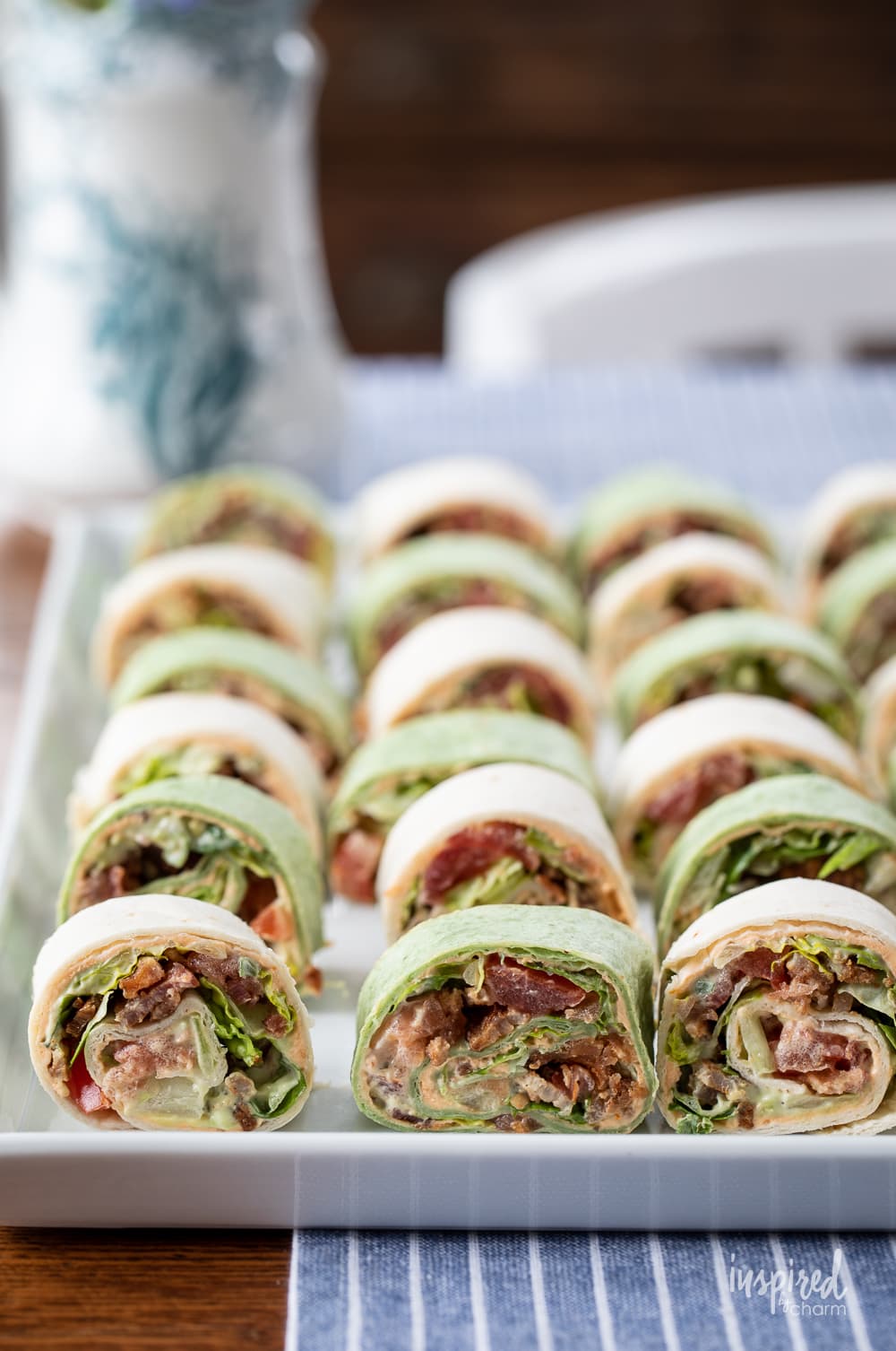 BLT Pinwheel Sandwiches on a platter on table with table runner.