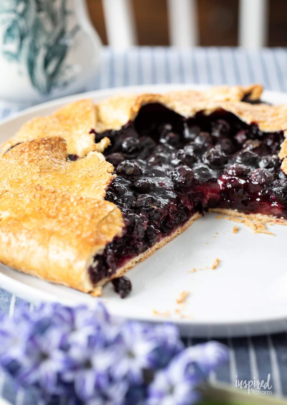 whole blueberry galette with a slice missing.