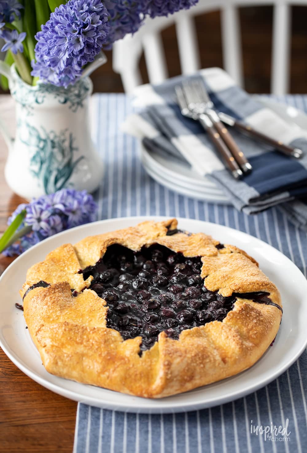 whole blueberry galette on platter on table.
