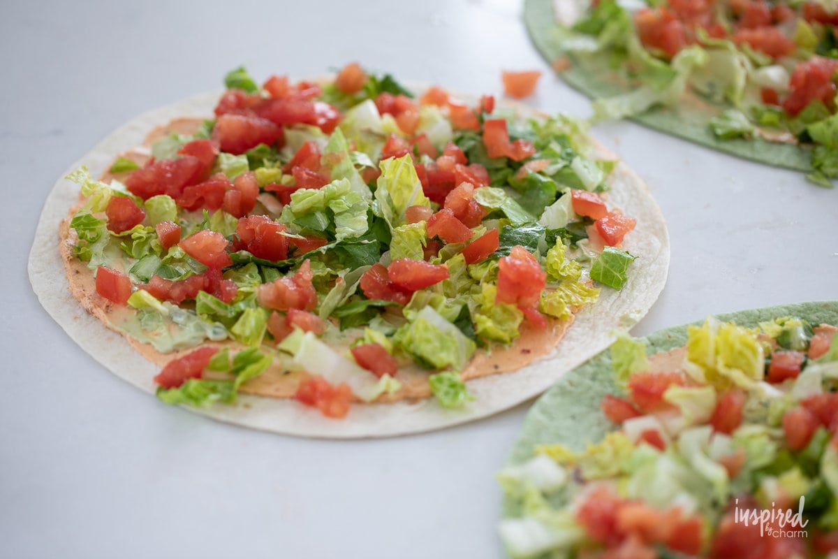 romaine lettuce and tomatoes on a flour tortilla to make pinwheels.