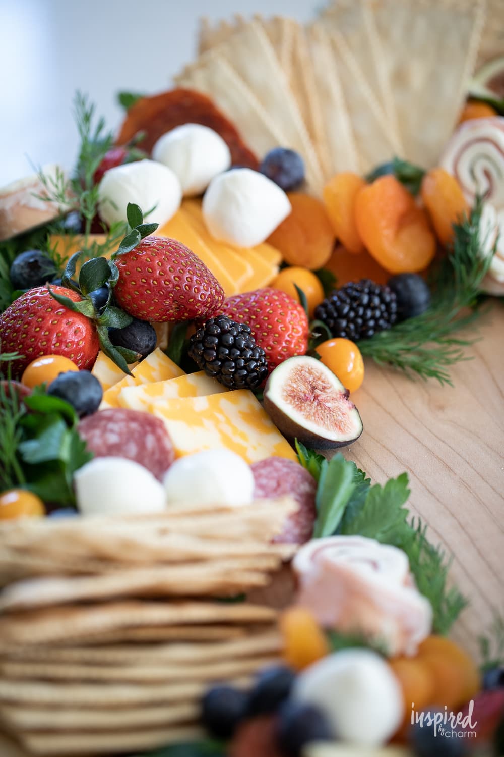 close up picture of food items on a charcuterie wreath.