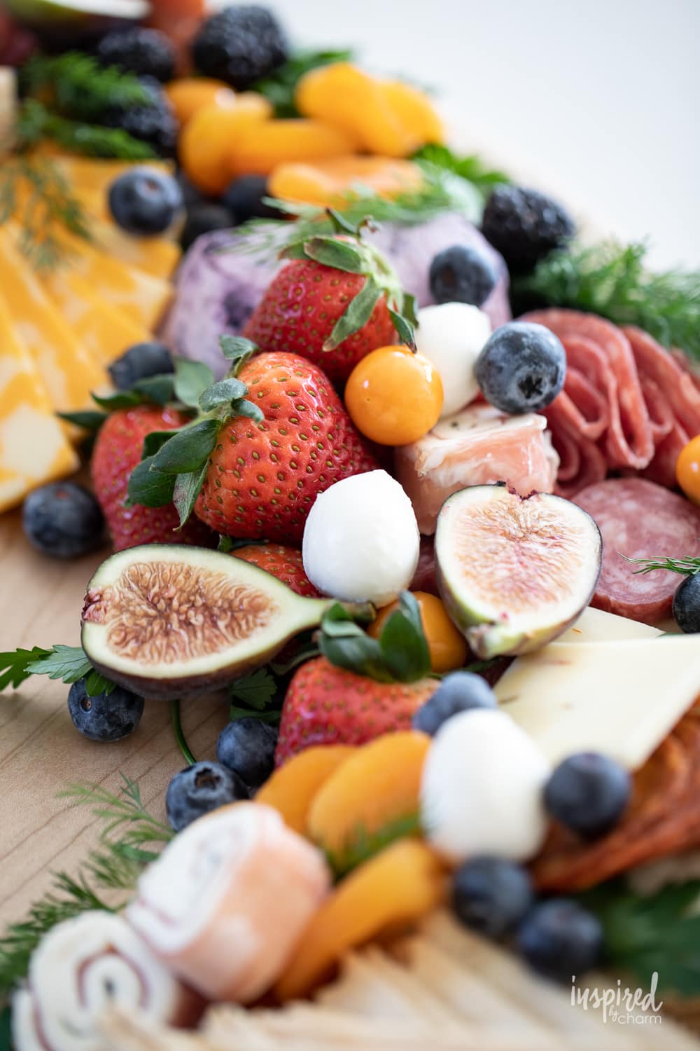 an array of ingredients on a charcuterie board shaped liked a wreath.