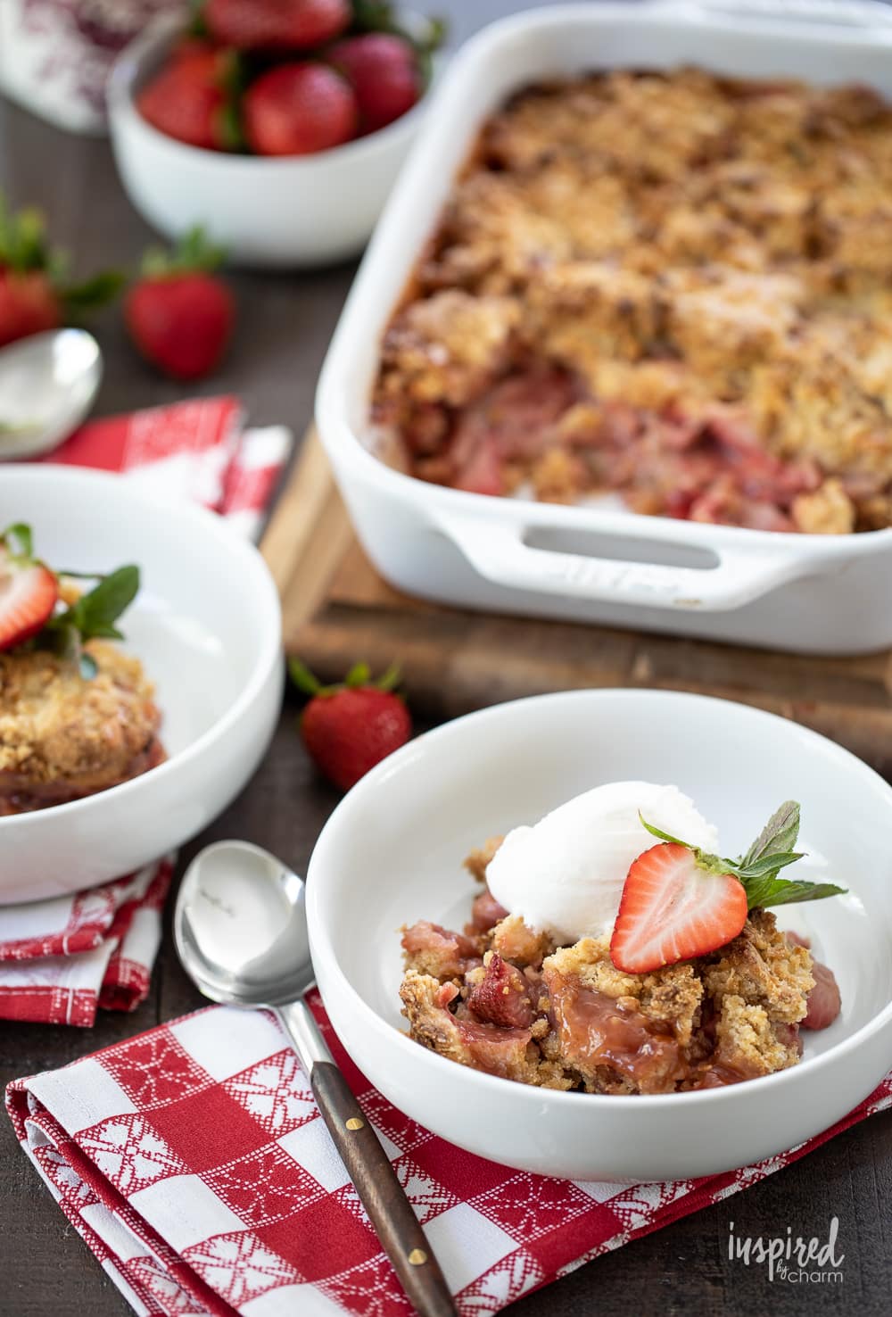 strawberry crumble in a baking dish and served in two bowls with ice cream.