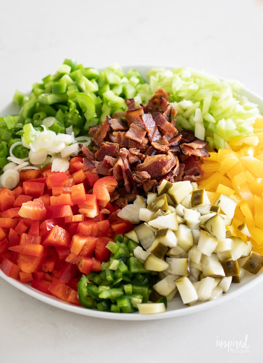 cajun potato salad ingredients arranged in groups on a plate.