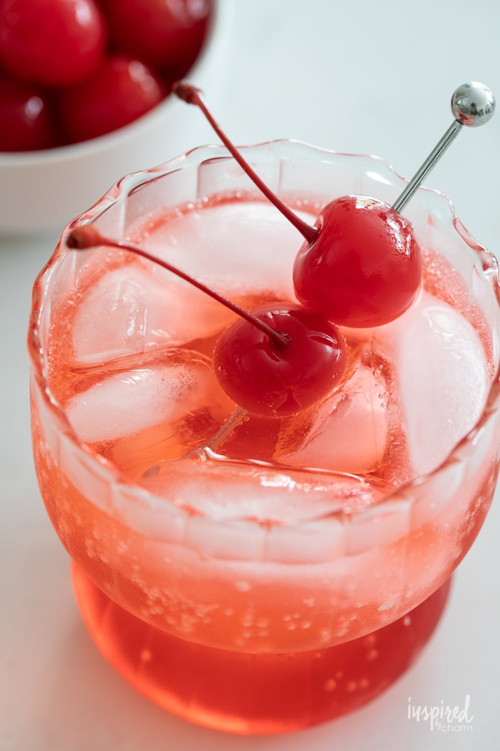 close up of cherries in dirty shirley cocktail.
