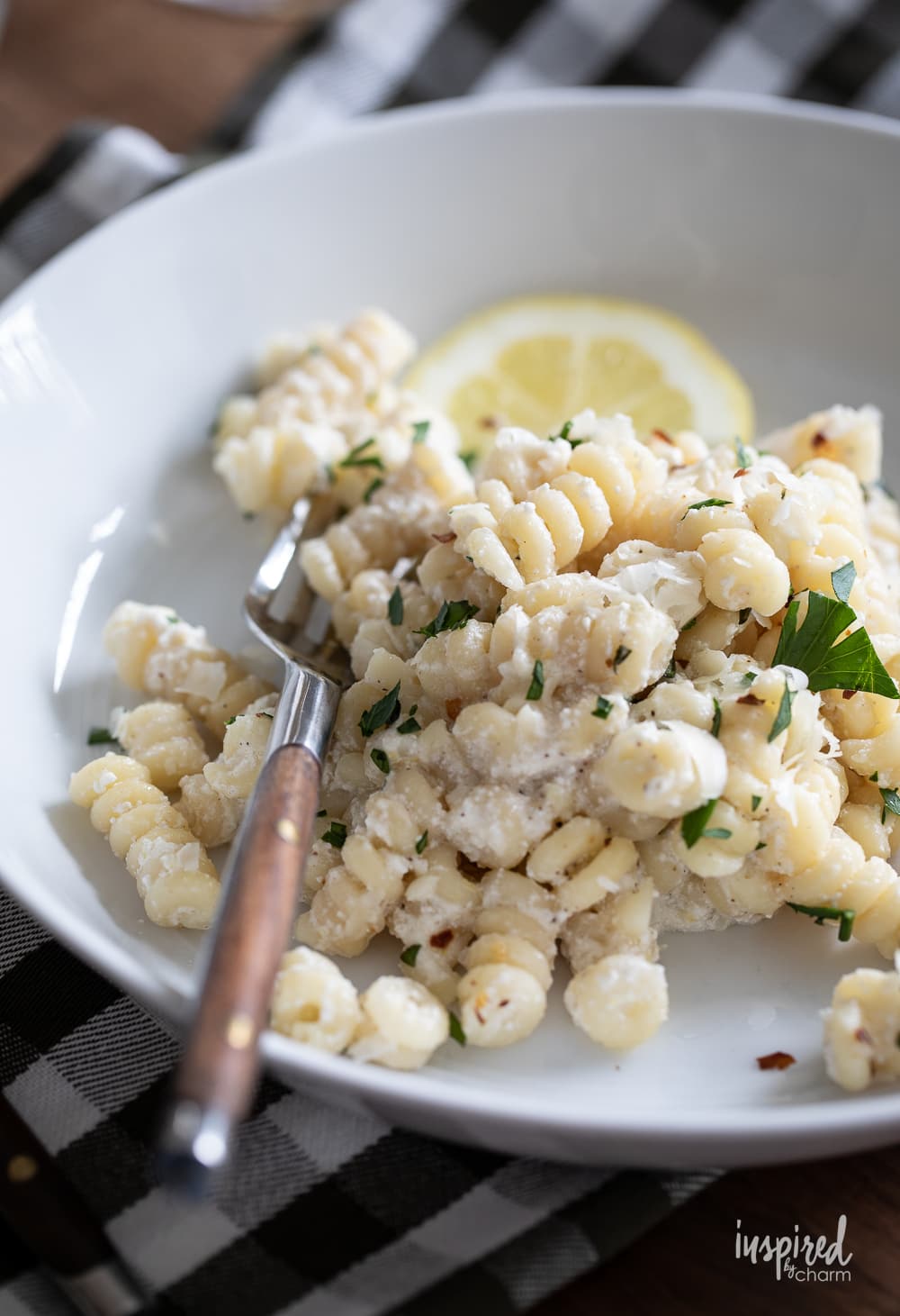 lemon ricotta pasta in a bowl with a fork. 