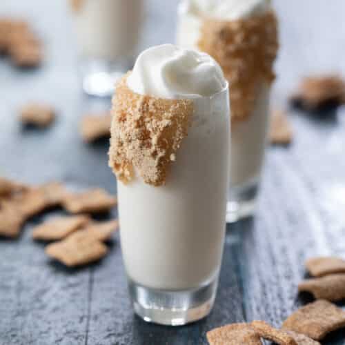 three Cinnamon Toast Crunch Shots with whipped topping.
