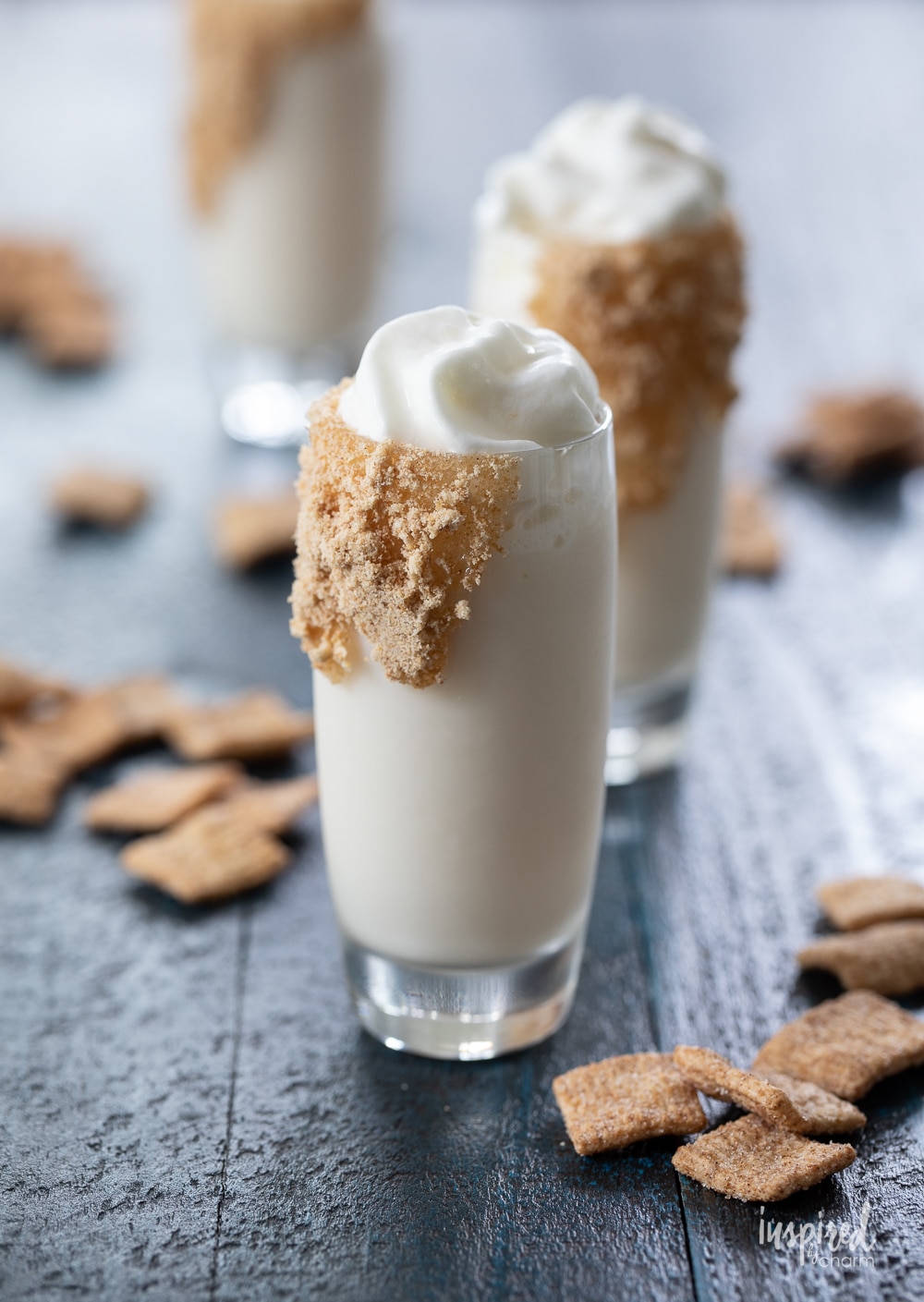 three Cinnamon Toast Crunch Shots with whipped topping.