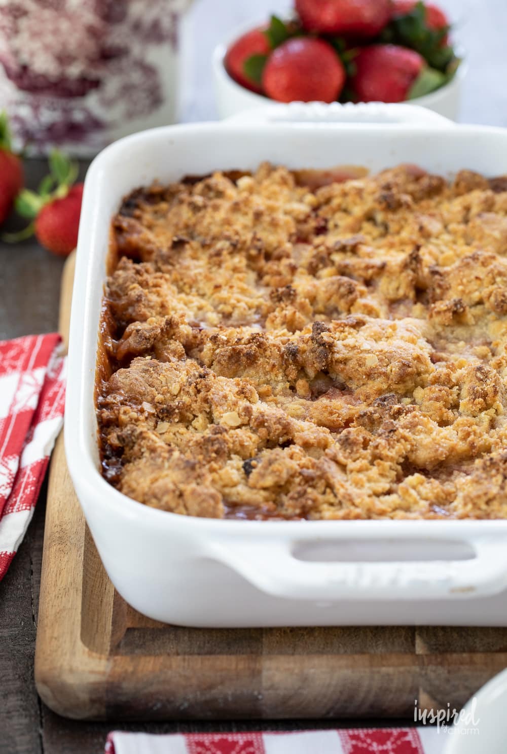 baked strawberry crumble in a white baking dish.