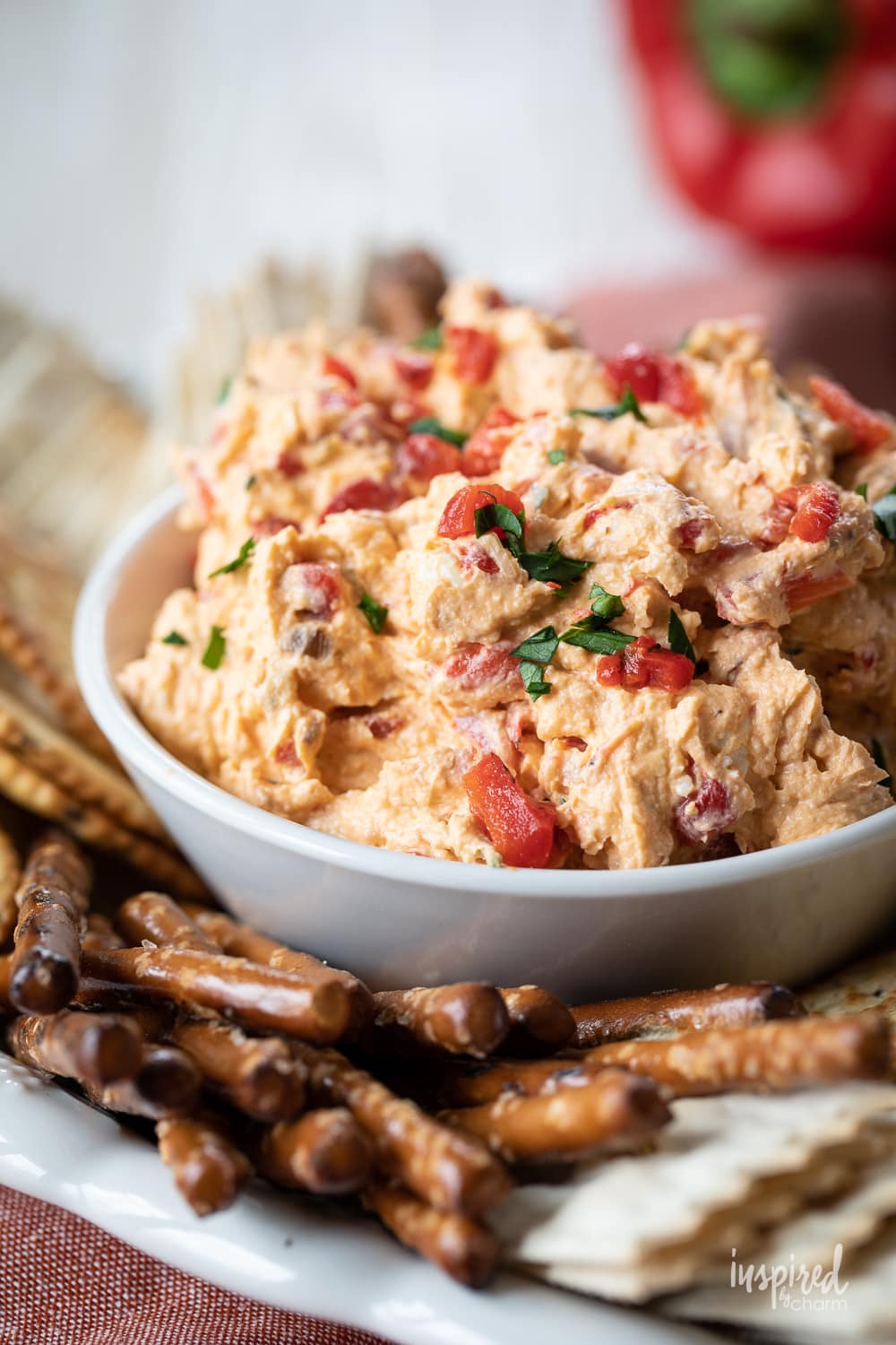 close up of roasted red pepper dip in a dish.