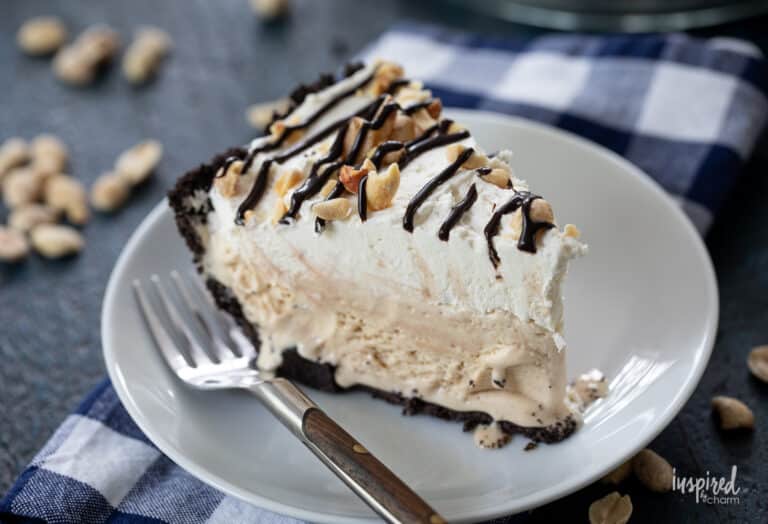 slice of peanut butter ice cream pie on a white plate with a fork.