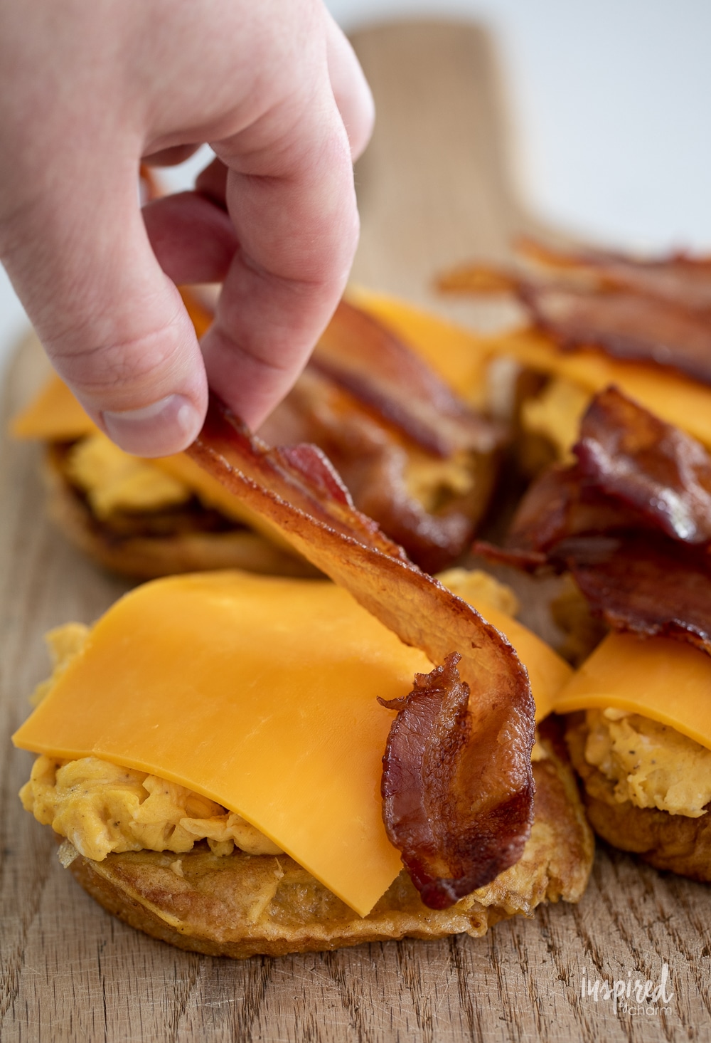 adding bacon to french toast breakfast sandwiches.