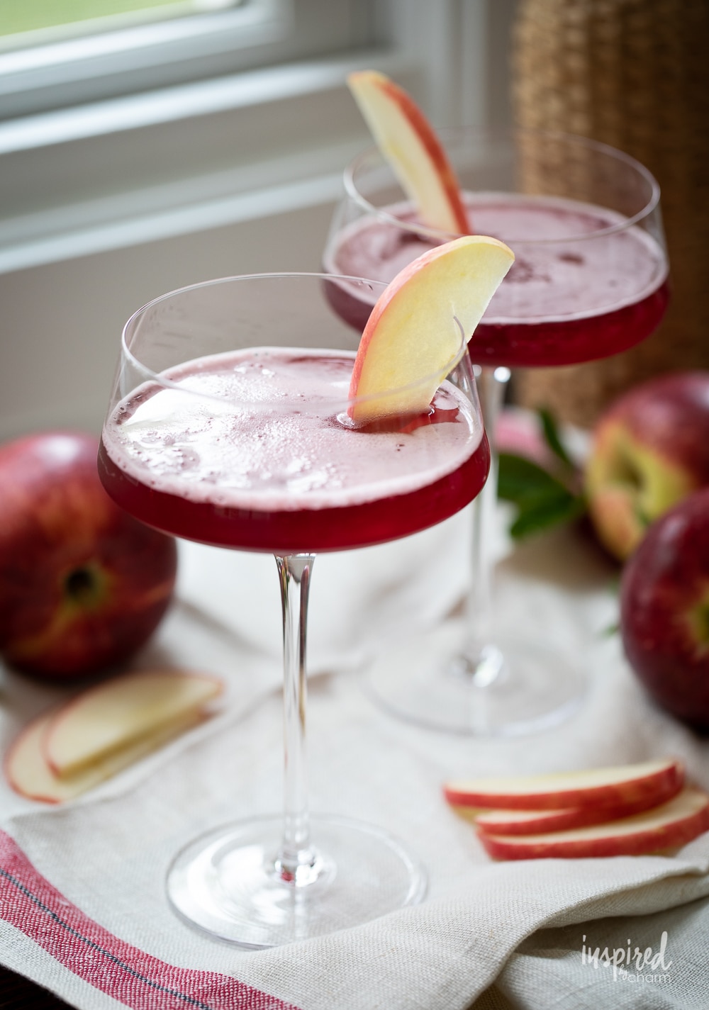 washington apple martini in glassed with apple garnish.
