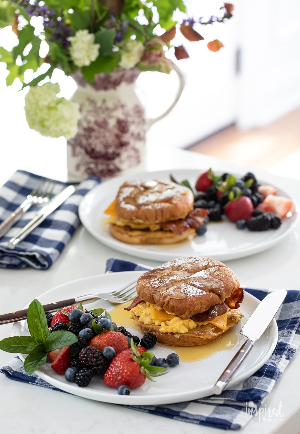 french toast breakfast sandwiches on plates on gingham napkins.