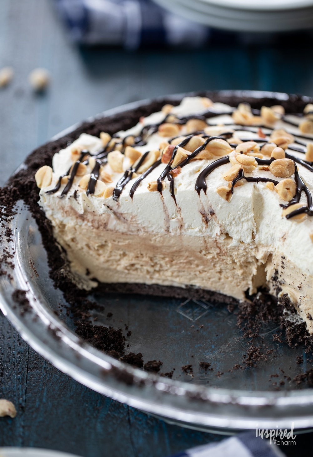 peanut butter ice cream pie in a clear glass pie plate with a piece removed.