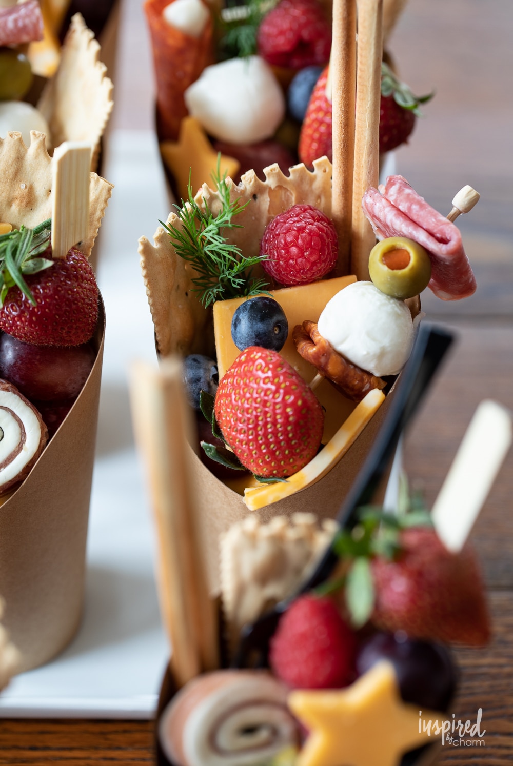 up close photo of charcuterie cups filled with snacks.