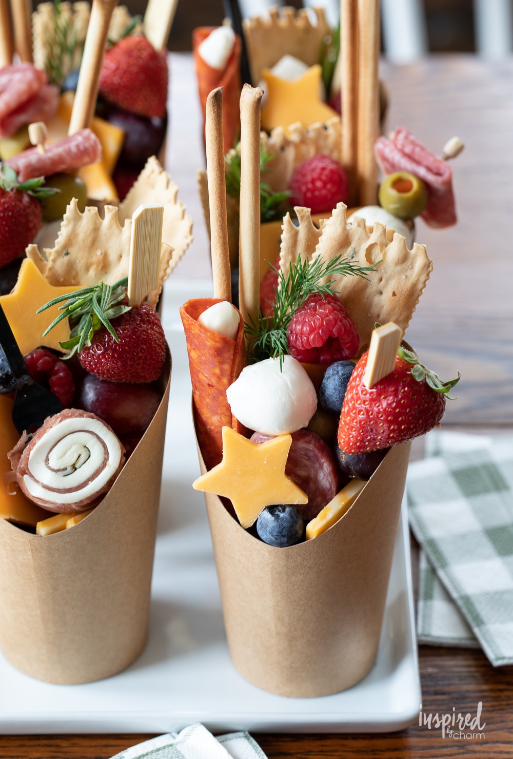 adorable charcuterie cups filled with snack stacked in a row.