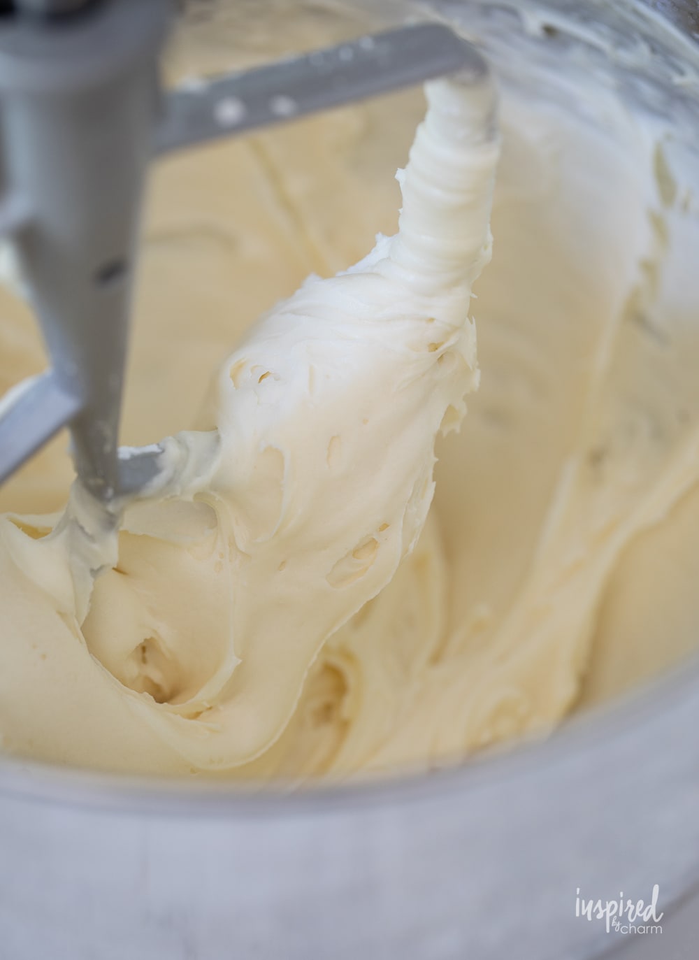 honey cream cheese frosting in the bowl of a stand mixer.