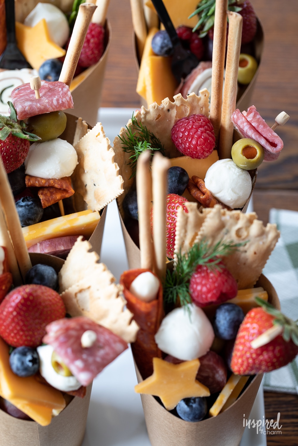 up close photo of charcuterie cups filled with snacks.