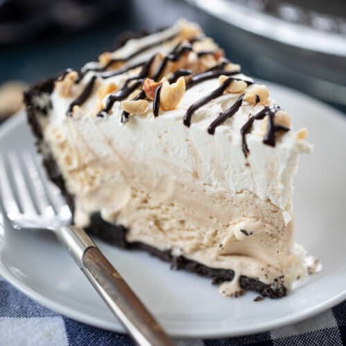 up close slice of peanut butter ice cream pie on a plate with a fork.