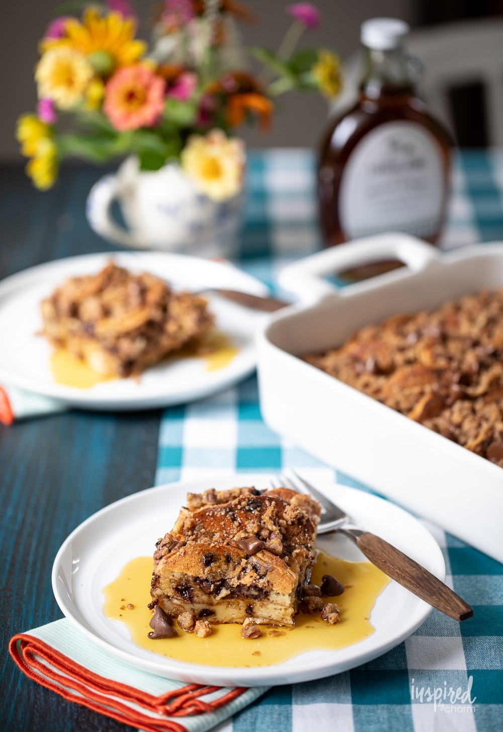 chocolate chip pancake casserole in baking dish and served on plates with maple syrup.