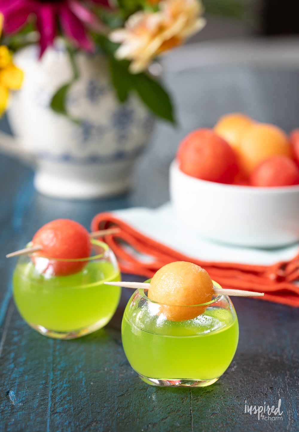 two melon ball shot in small round glass with watermelon and cantaloupe ball garnish. 