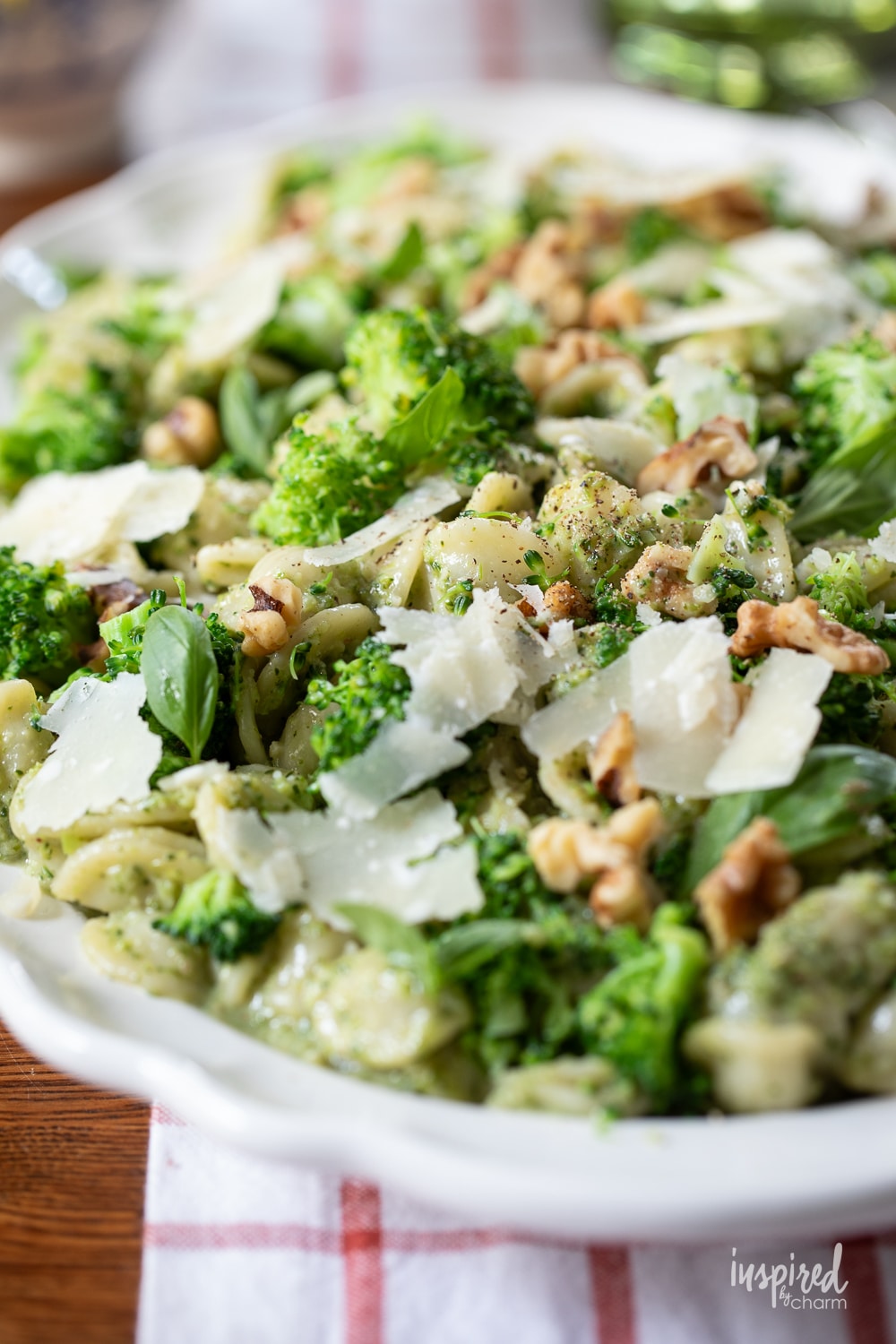 up close photo of broccoli pesto pasta served on a plate.