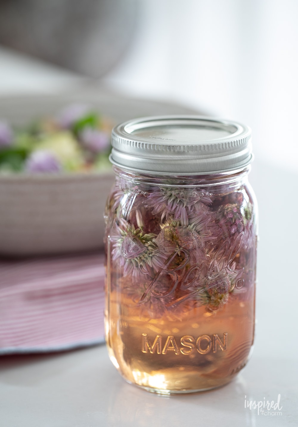 chive blossom vinegar in a mason jar.