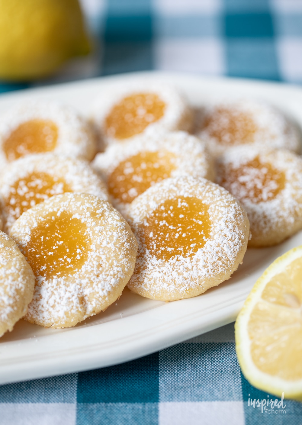 plate of lemon curd cookies with confectioners' sugar sprinkled on top.