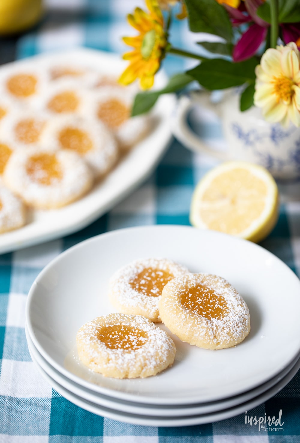 lemon curd cookies served on a platter with three on a plate.