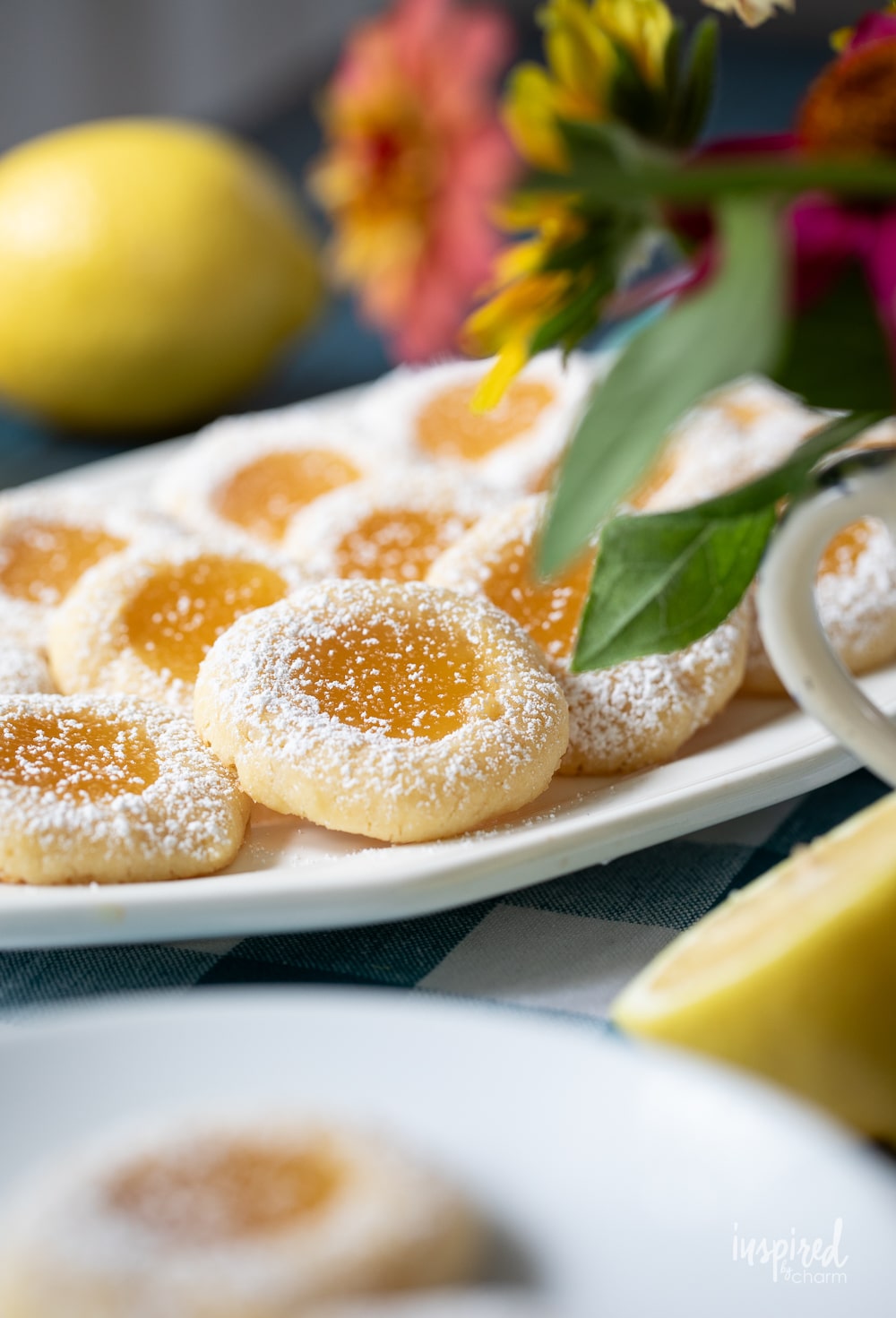 lemon curd cookies arranged in rows on a plate.