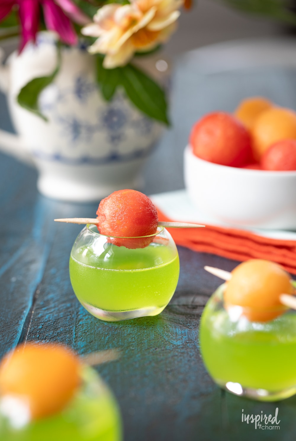 the best melon ball shot recipe in a small shot glass with melon ball garnish. 