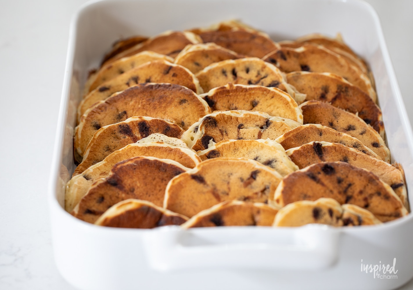 chocolate chip pancakes in a white baking dish.