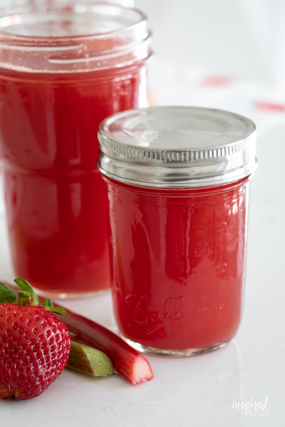 strawberry rhubarb syrup in a canning jar with metal lid.