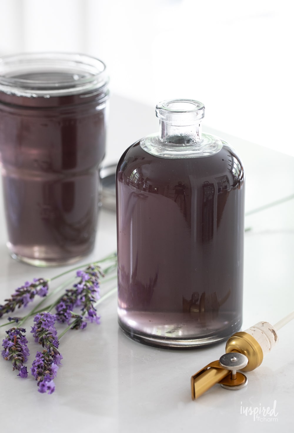 a bottle and a jar filled with lavender simple syrup.