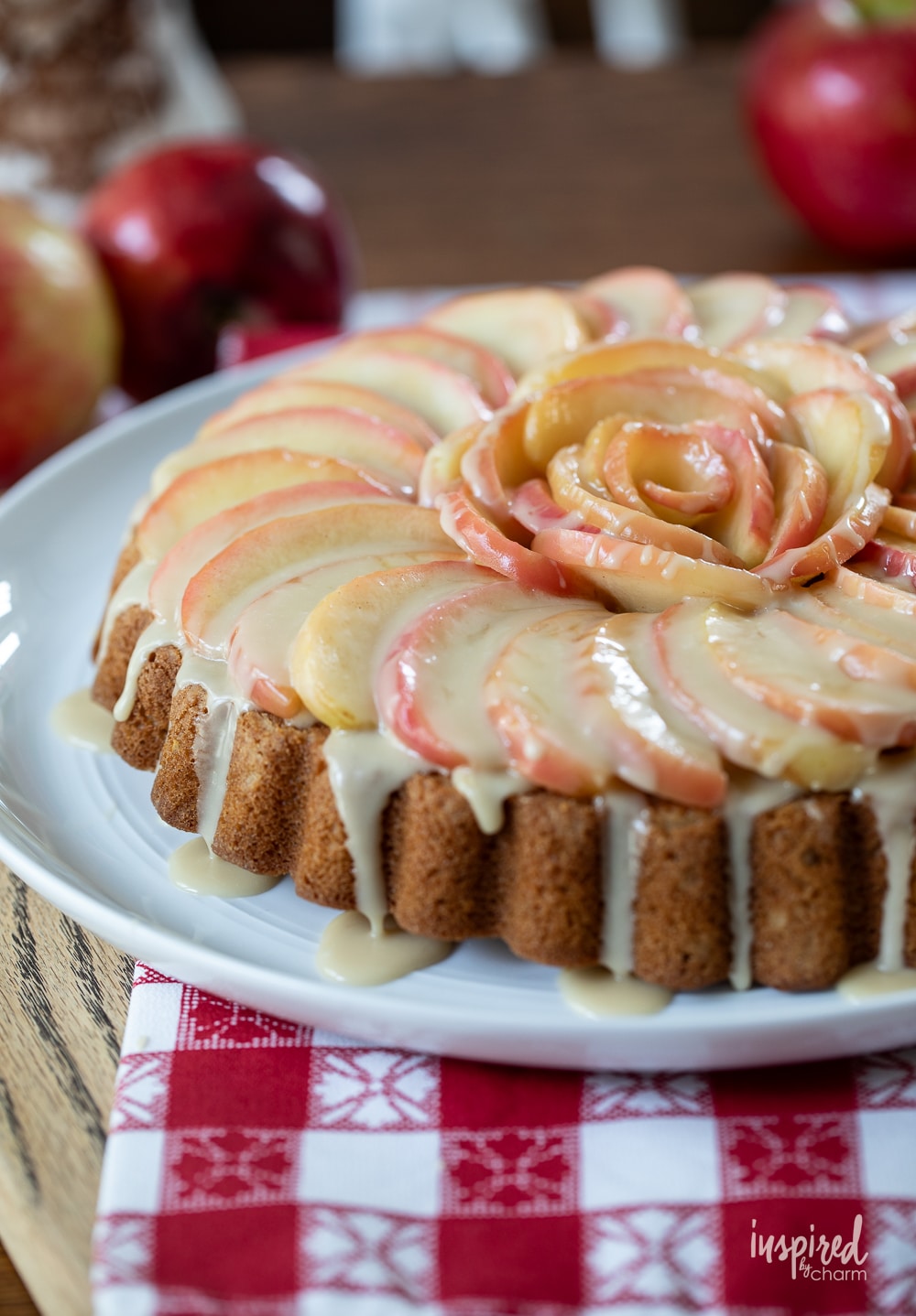 close up of a fresh apple cake on a large white plate.