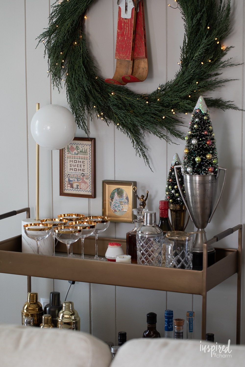 bar cart decorated for christams with vintage artwork hung on the walls. 