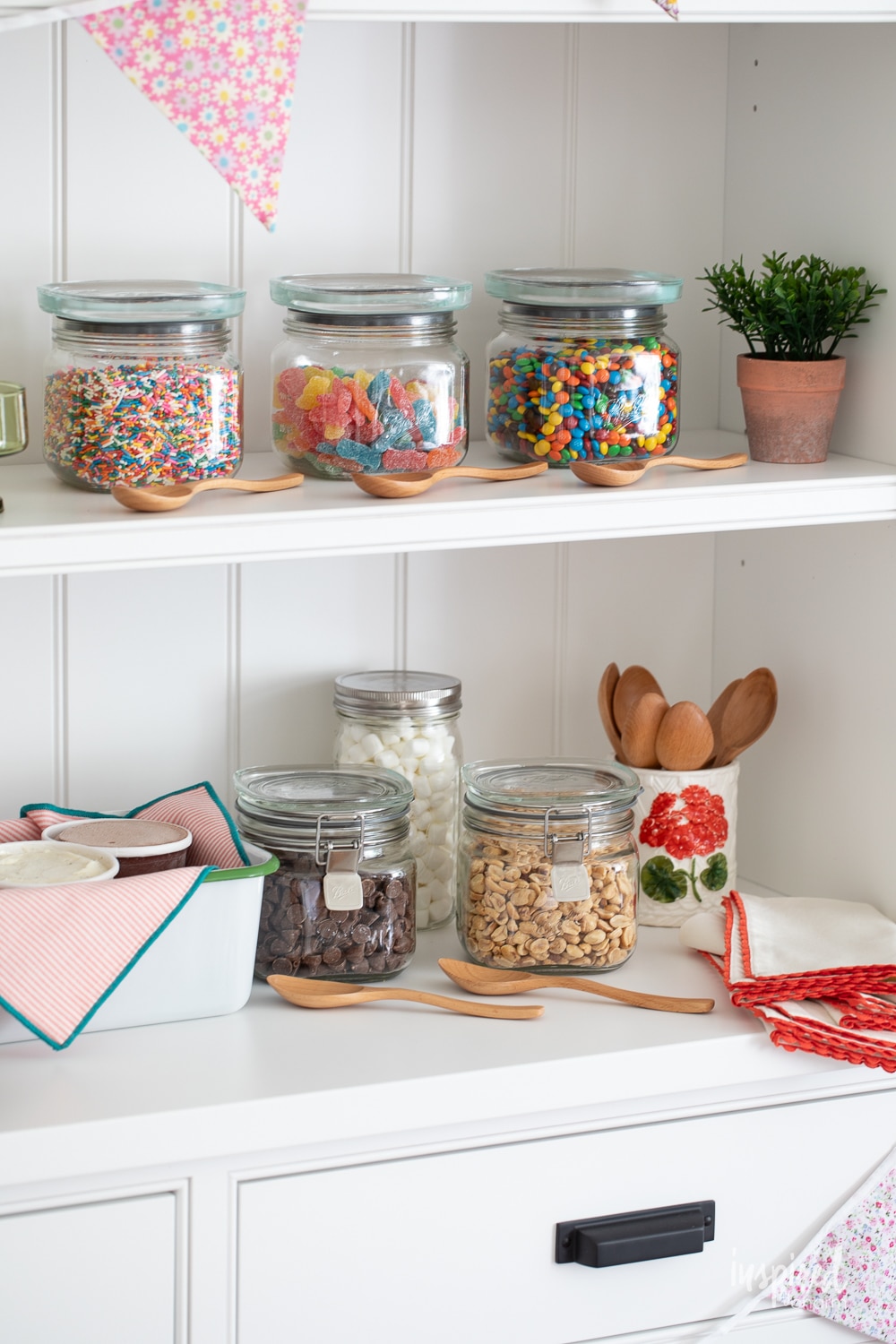 toppings for an ice cream sundae bar display in glass storage jars. 
