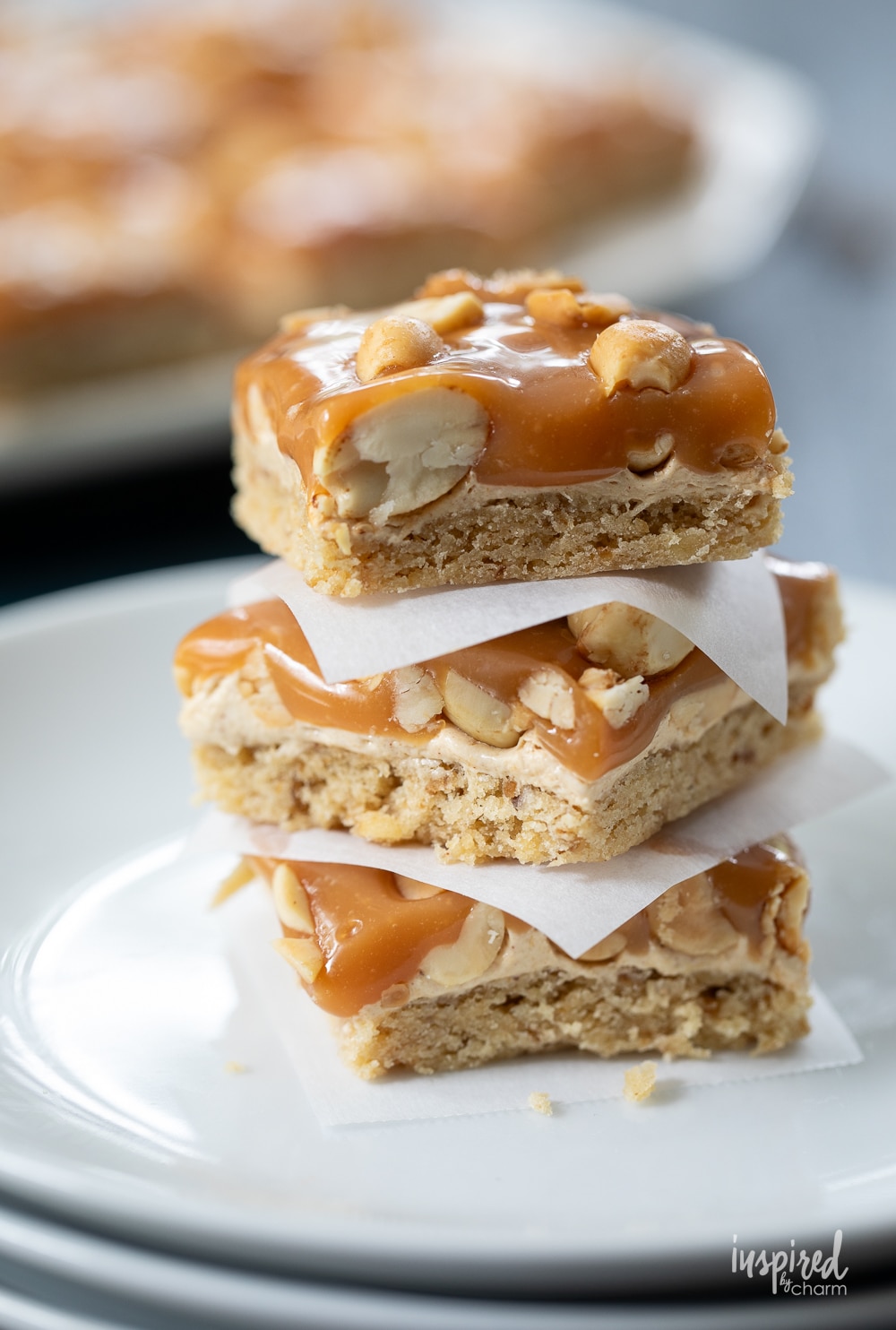 close up of three salted peanut bars stacked on top of each other.