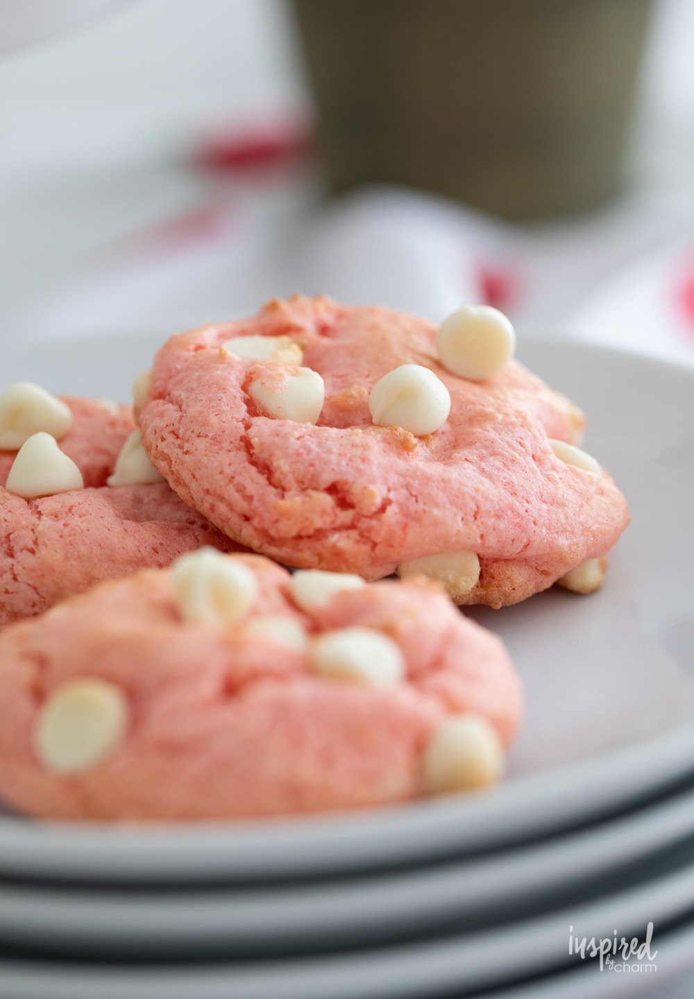 up close of strawberry cake mix cookies on a small plate. 