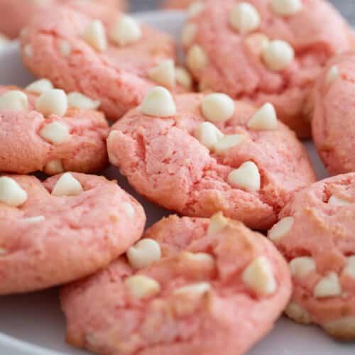 plate of strawberry cake mix cookies with white chocolate chips.