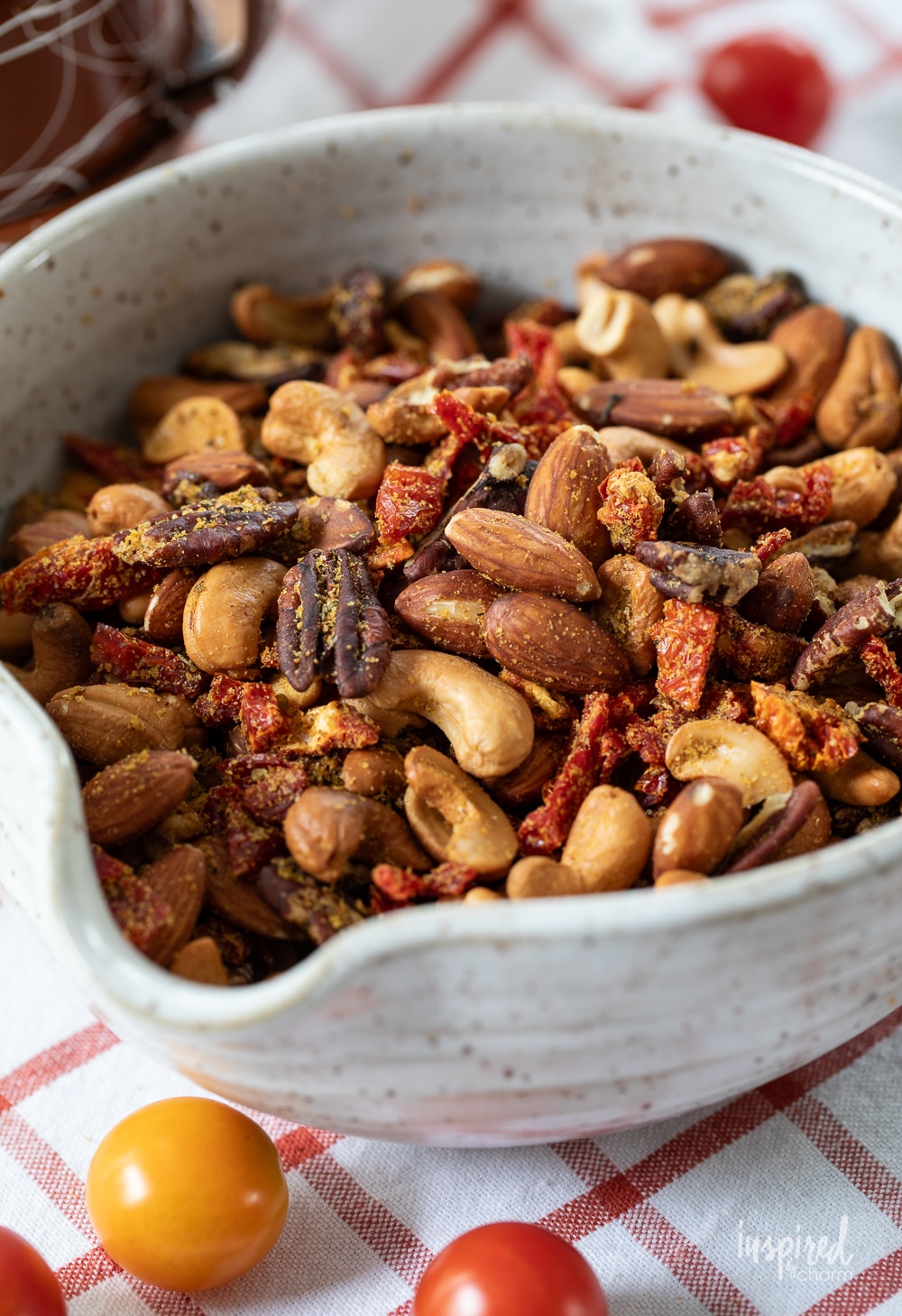 big bowl of pizza trail mix with nuts and sun-dried tomatoes.