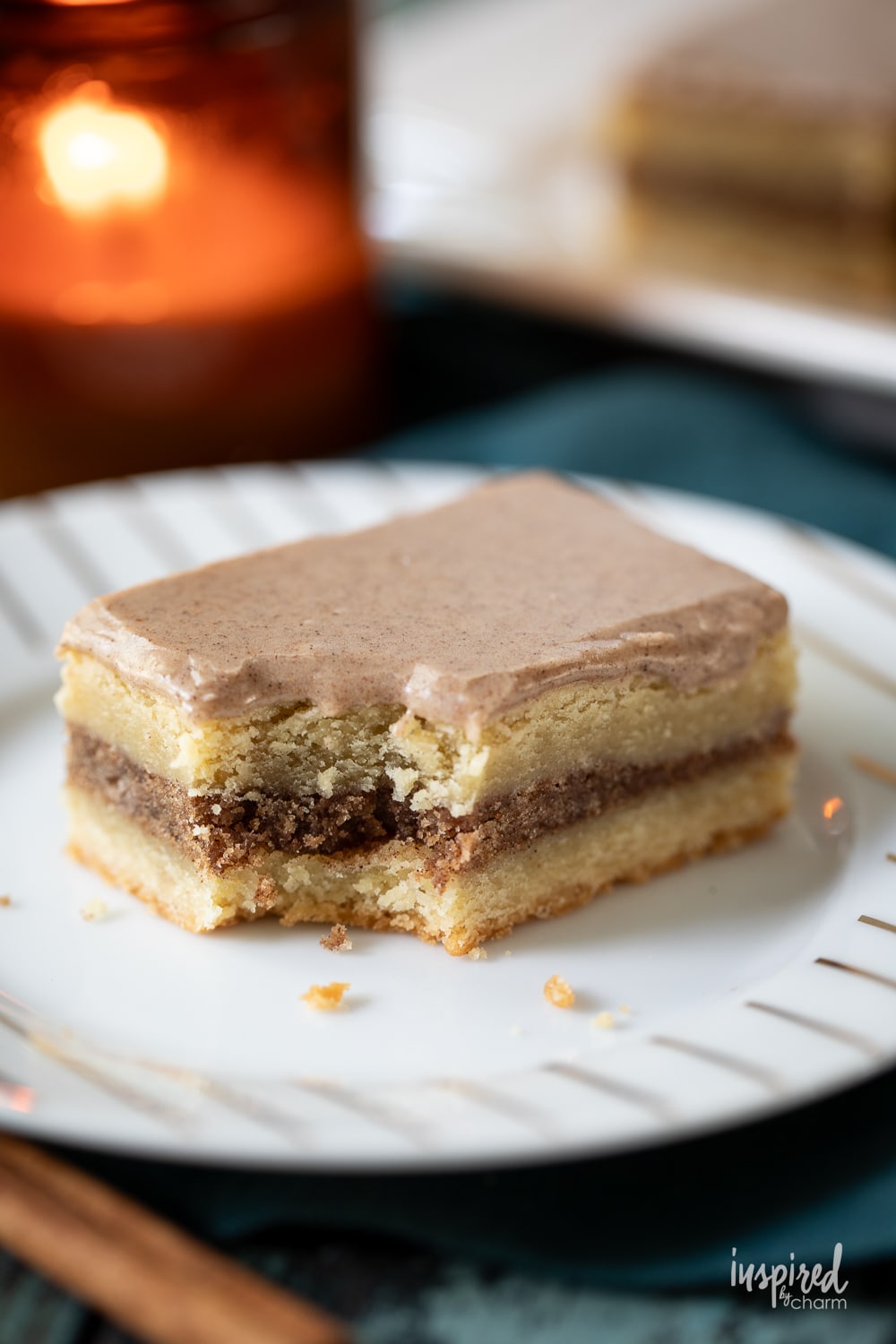 brown sugar cinnamon pop tart bar on a plate with a bite removed.