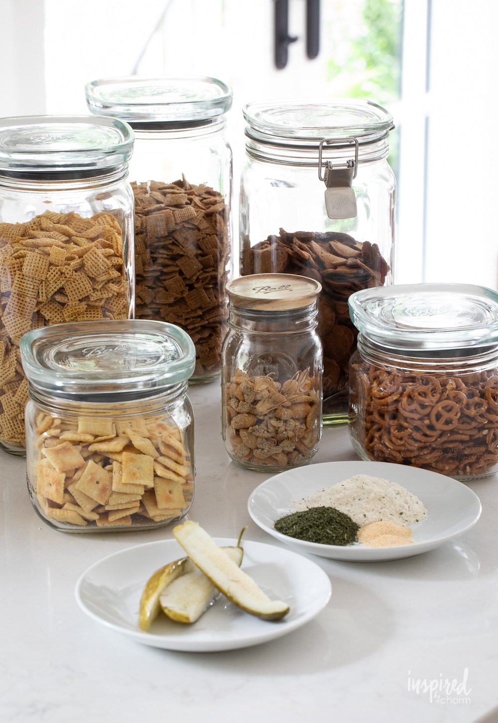 dill pickle snack mix in glass storage jars. 